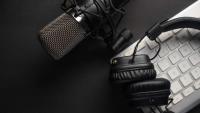Studio microphone with professional headphones on a PC keyboard